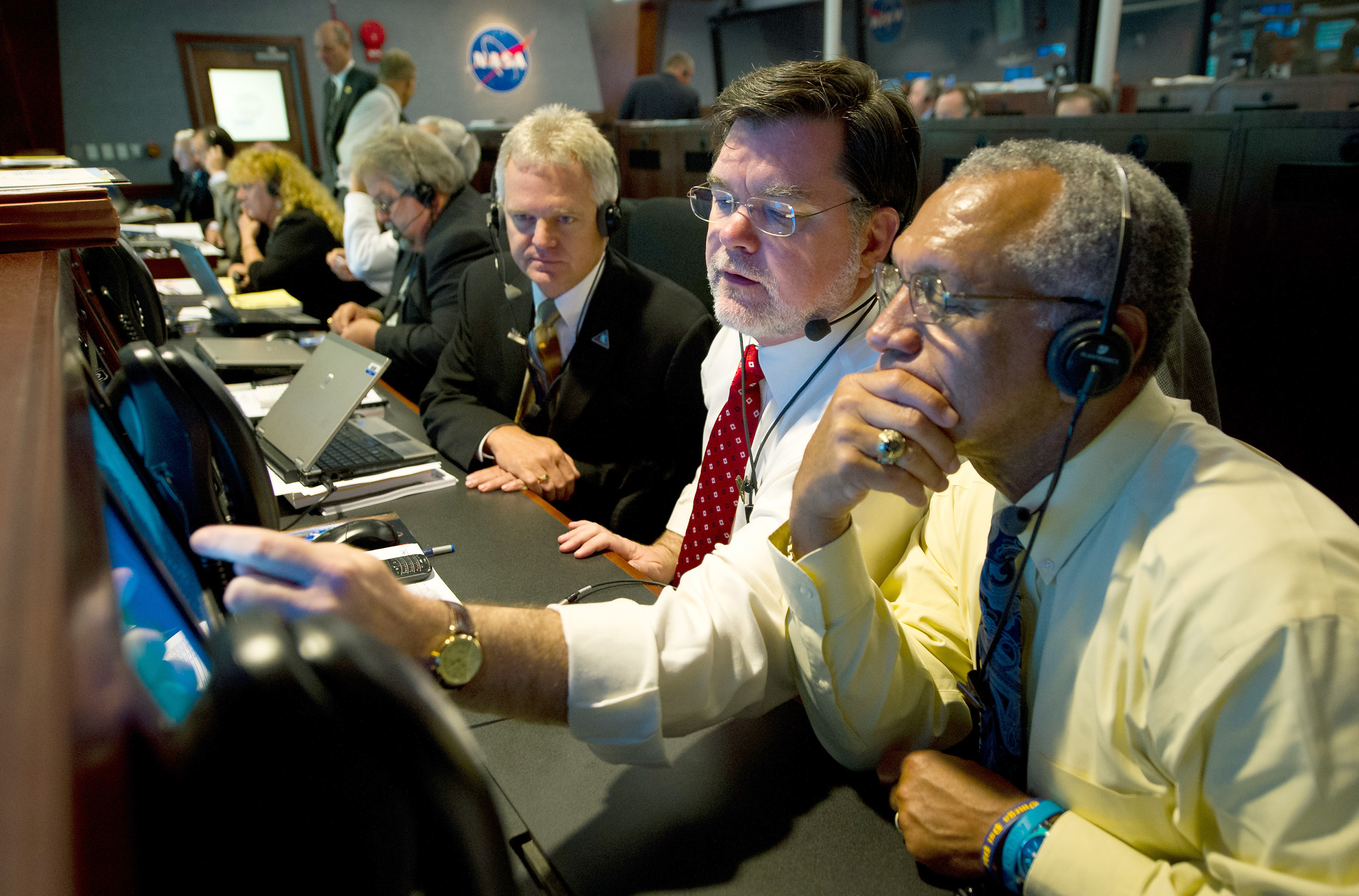 Then NASA Deputy Director of Planetary Division Jim Adams, center, and NASA Administrator Charles Bolden, right, review incoming data during the countdown to launch of the twin GRAIL spacecraft in 2011 at the Cape Canaveral Air Force Station. Credit: NASA/Bill Ingalls