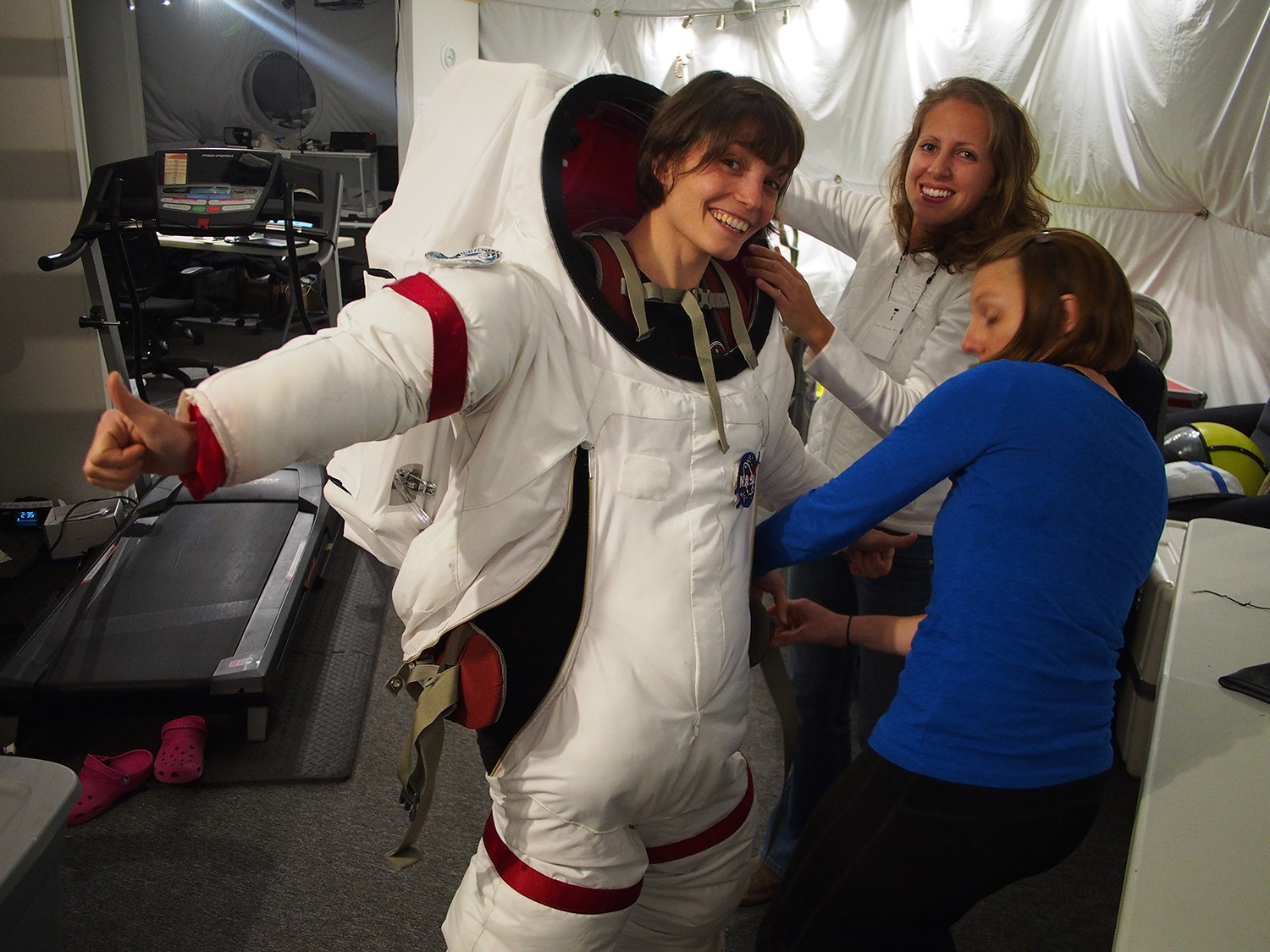 Lucie Poulet gets help suiting up for a EVA from her fellow crew members Annie Caraccio and Tiffany Swarmer.ccCredit: Ross Lockwood