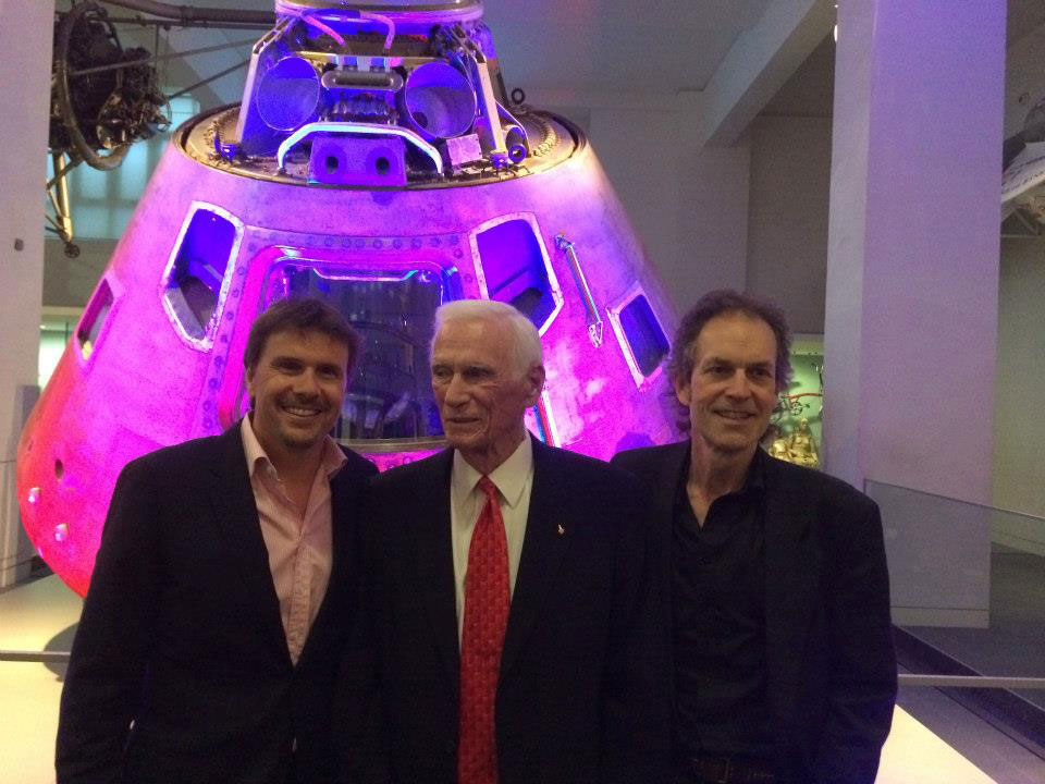 L-R Executive Producer Mark Stewart, Gene Cernan and Director Mark Craig stand in front of Cernan’s Apollo 10 Command Module “Charlie Brown” at London’s Science Museum. Credit: Mark Stewart Productions