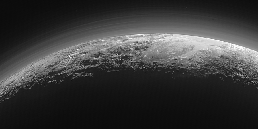black and white crsecent image of pluto's surface and atmosphere