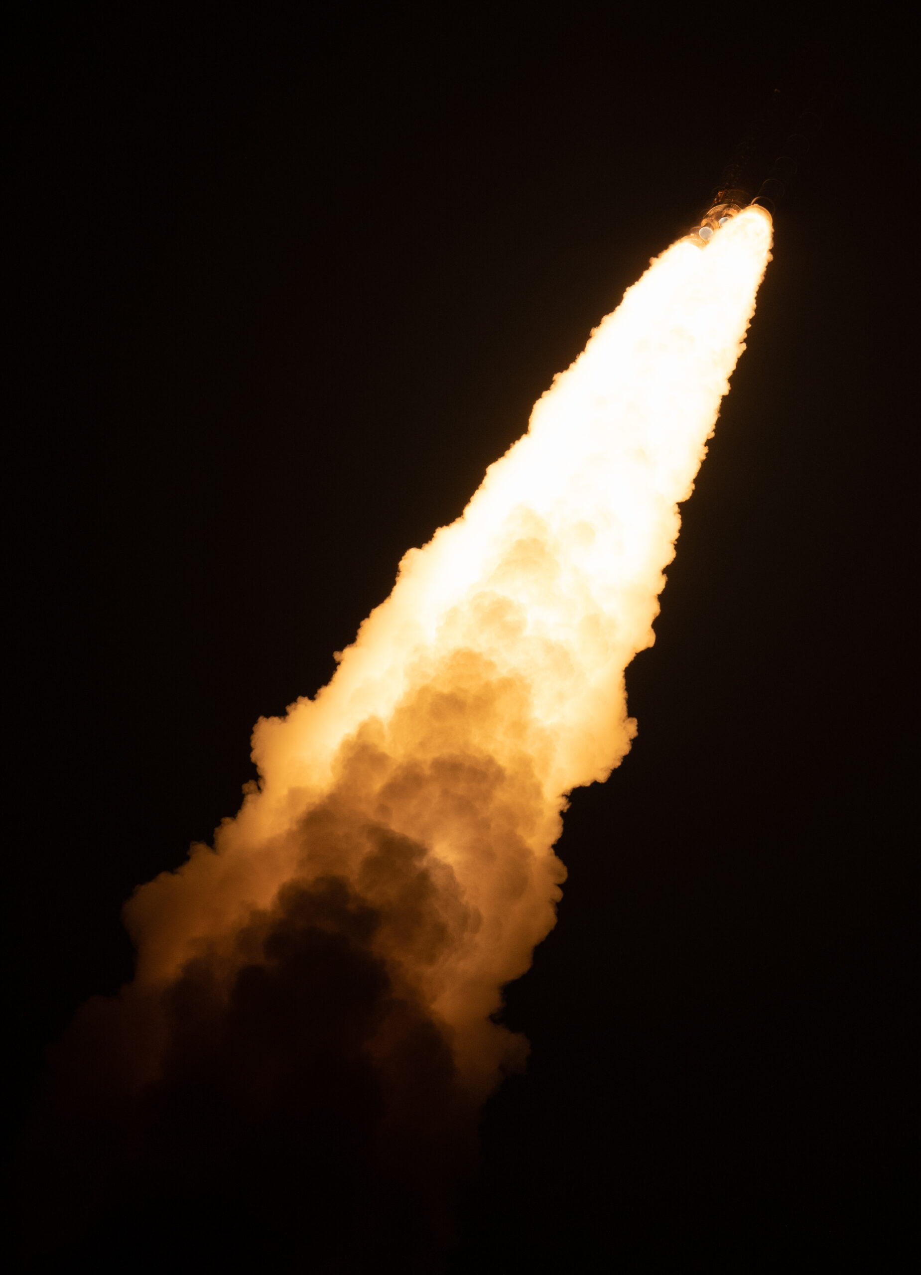 massive rocket plume of sls artemis rocket during nighttime launch