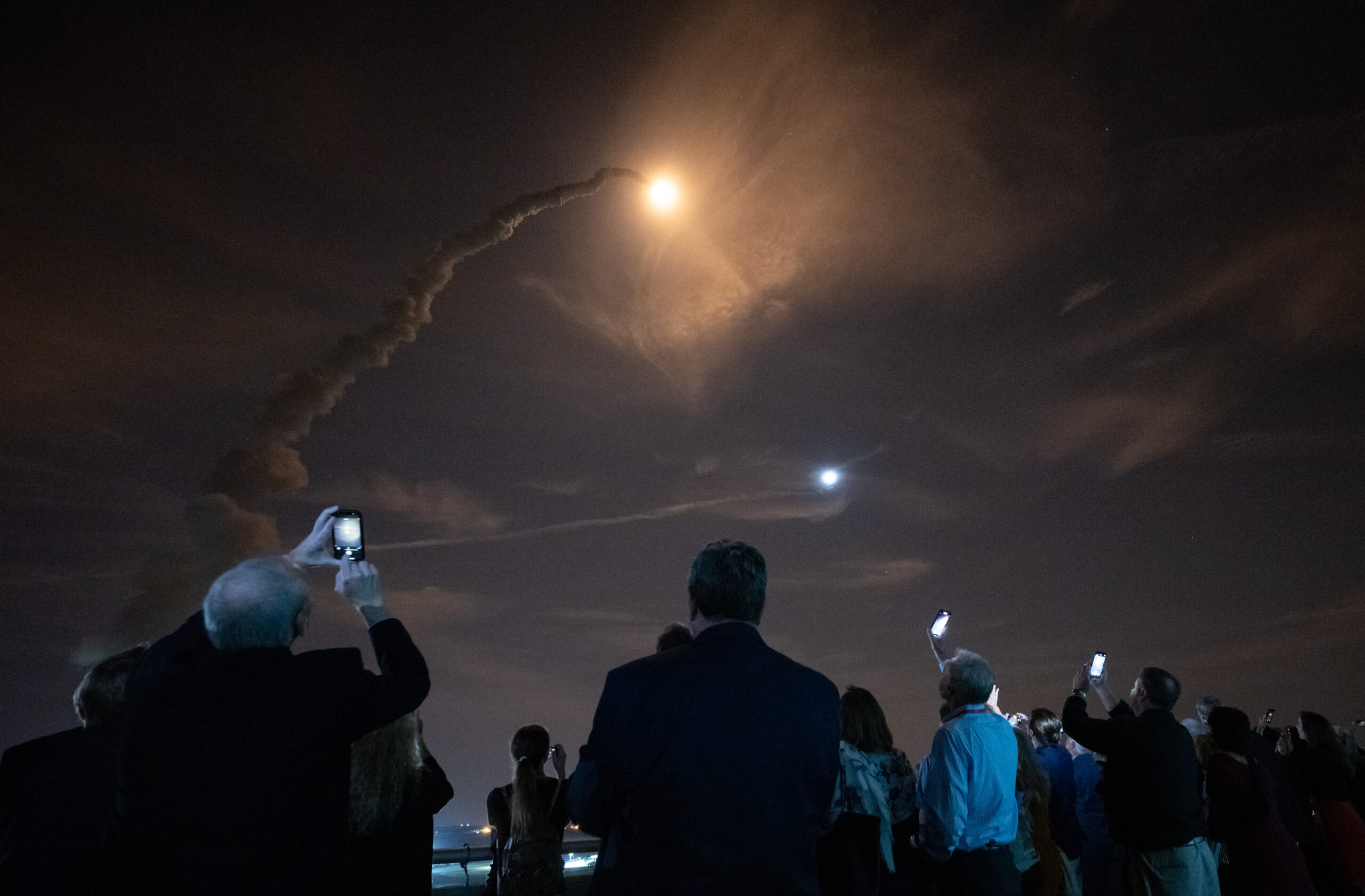 smoke trail of artemis rocket launch into florida's night sky